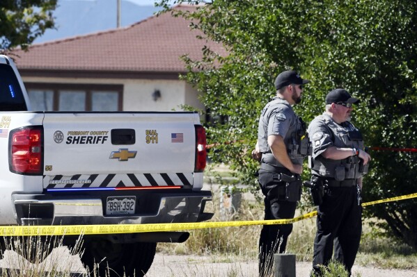 Fremont County deputies guard the road leading to the Return to Nature Funeral Home in Penrose, Colo. Thursday, Oct. 5, 2023. Authorities said Thursday they were investigating the improper storage of human remains at a southern Colorado funeral home that performs “green” burials without embalming chemicals or metal caskets. (Jerilee Bennett/The Gazette via AP) /The Gazette via AP)