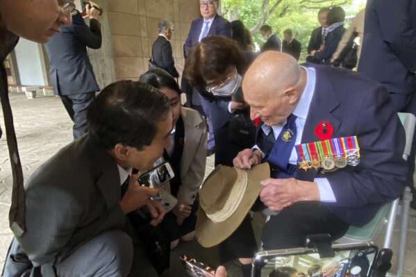 Richard Day, 97, right, a British army veteran who survived the Burma Campaign, one of the harshest battles in the World War II, talks to Yukihiro Torikai, left, a Tokai University humanities professor whose late grandfather also fought in the campaign, during a memorial at the Chidorigafuchi National Cemetery in Tokyo, Monday, Oct. 9, 2023. The memorial was attended by military officials from the embassies of several former allied nations, including Australia, Britain, New Zealand and the U.S. at the cemetery for the unknown Japanese who died overseas during the war. (AP Photo/Mari Yamaguchi)