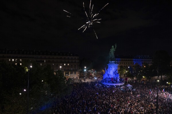 People gather at Republique plaza to protest the far-right National Rally, which came out strongly ahead in first-round legislative elections, in Paris, Sunday, June 30, 2024. (AP Photo/Louise Delmotte)