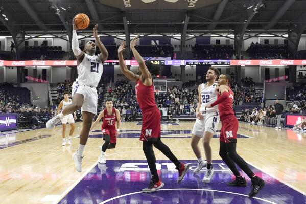 Northwestern's Elyjah Williams (21) shoots over Nebraska's Quaran Mcpherson during the first half of an NCAA college basketball game Tuesday, Feb. 22, 2022, in Evanston, Ill. (AP Photo/Charles Rex Arbogast)