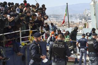 FILE - Migrants disembark from a ship in the Sicilian port of Catania, Wednesday, April 12, 2023. European Union lawmakers approved on Thursday, April 20, 2023 a series of proposals aimed at ending the years-long standoff over how best to manage migration, a conundrum that has provoked one of the bloc's biggest political crises. (AP Photo/Salvatore Cavalli, File)