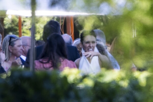 Former New Zealand Prime Minister Jacinda Ardern, front right, mingles with guests at her wedding to Clarke Gifford at a vineyard in Havelock North, New Zealand, Saturday, January 13, 2024. (George Heard/New Zealand Herald via AP)
