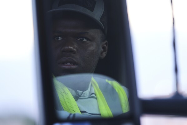 Haitian immigrant Kevenson Jean, a truck driver, checks his truck before a road trip, Tuesday, April 15, 2025, in Panhandle, Texas. (AP Photo/Eric Gay)