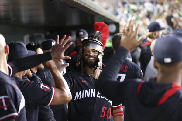 Minnesota Twins' Willi Castro (50) celebrates with teammates after hitting his second solo home run of the night against the Athletics during the sixth inning of a baseball game Tuesday, June 3, 2025, in West Sacramento, Calif. (AP Photo/Scott Marshall)