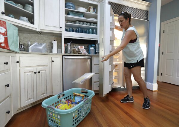 
              Michelle Stober, of Cary, N.C., removes food from a freezer as she prepares their vacation home in advance of Hurricane Florence in Wrightsville Beach, N.C., Tuesday, Sept. 11, 2018. Florence exploded into a potentially catastrophic hurricane Monday as it closed in on North and South Carolina, carrying winds up to 140 mph (220 kph) and water that could wreak havoc over a wide stretch of the eastern United States later this week. (AP Photo/Chuck Burton)
            