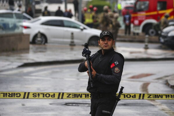A member of Turkish security forces stands guard near a cordoned off area after an explosion in Ankara, Sunday, Oct. 1, 2023. A suicide bomber detonated an explosive device in the heart of the Turkish capital, Ankara, on Sunday, hours before parliament was scheduled to reopen after a summer recess. A second assailant was killed in a shootout with police. (AP Photo/Ali Unal)