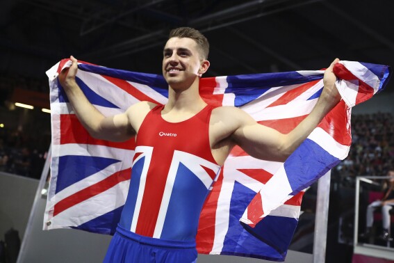 FILE - Max Whitlock of Great Britain celebrates winning the gold medal on the pommel horse in the men's apparatus finals at the Gymnastics World Championships in Stuttgart, Germany, Saturday, Oct. 12, 2019. Triple Olympic gold medalist Max Whitlock says he will end his 24-year gymnastics career after the Paris Olympics. (AP Photo/Matthias Schrader, File)