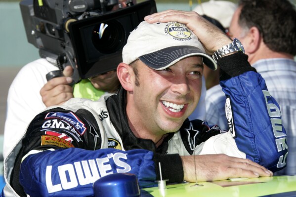 FILE - Crew chief Chad Knaus grins as he leans on the race car of NEXTEL Cup Series points leader Jimmie Johnson prior to the season finale Ford 400 auto race at Homestead-Miami Speedway in Homestead, Fla., Nov. 19, 2006. Jimmie Johnson and former crew chief Chad Knaus, who combined to win a record-tying seven Cup Series championships, have been selected for the NASCAR Hall of Fame. They will be joined by longtime driver Donnie Allison, who was voted in on the pioneer ballot. (AP Photo/Terry Renna, File)