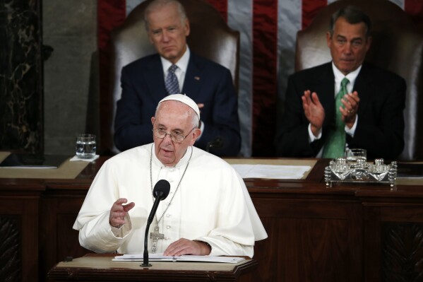 Pope Francis addresses a joint meeting of Congress on Capitol Hill in Washington, Sept. 24, 2015, making history as the first pontiff to do so. Listening behind the pope are Vice President Joe Biden and House Speaker John Boehner of Ohio. (AP Photo/Carolyn Kaster)