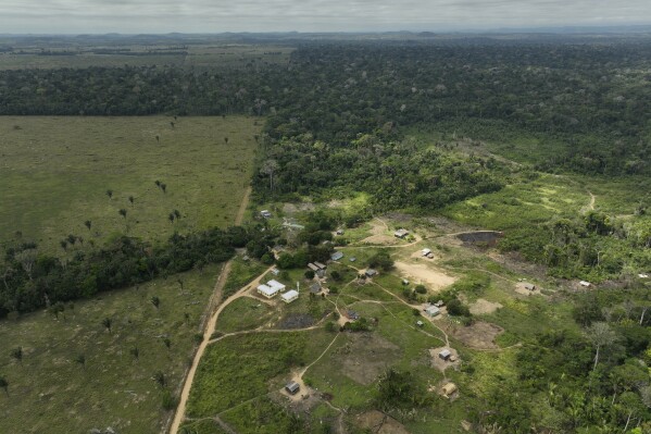 The Linha 26 Indigenous Wari' community, lies next to a deforested area in Nova Mamore, Rondonia state, Brazil, Friday, July 14, 2023. On June 6, about 60 armed men invaded the village, expelling its inhabitants. They only returned after the Federal Police went to the locale and retook it, according to the Wari’ umbrella organization. (AP Photo/Andre Penner)
