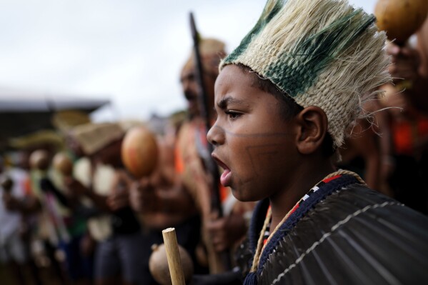 Indigenous people march during the annual Free Earth camp, where they discuss rights, territorial protection and their role in COP30 which will take place for the first time in the Amazon, in Brasilia, Brazil, Tuesday, April 8, 2025. (AP Photo/Eraldo Peres)
