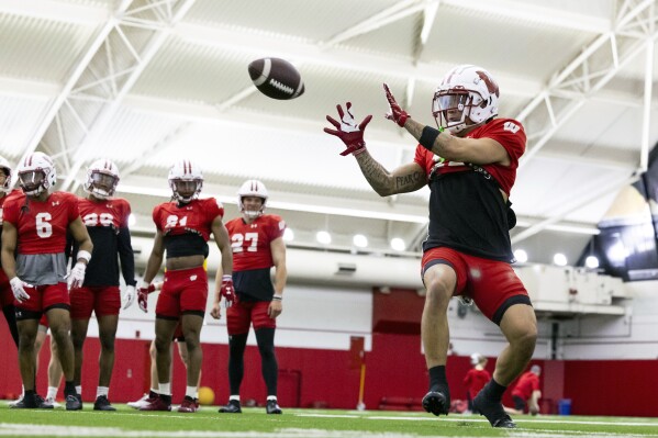 FILE - Wisconsin wide receiver Trech Kekahuna (12) catches a pass during spring NCAA college football practice at the McClain Center in Madison, Wisc., Thursday, April 4, 2024. Kekahuna looks to build off a strong performance against LSU in the Reliaquest Bowl after he didn't catch a pass during the regular season as a freshman.(Samantha Madar/Wisconsin State Journal via AP, File)