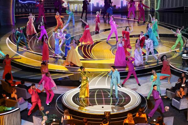 Becky G, center left, and Luis Fonsi, center right, perform "We Don't Talk About Bruno" from "Encanto" at the Oscars on Sunday, March 27, 2022, at the Dolby Theatre in Los Angeles. (AP Photo/Chris Pizzello)