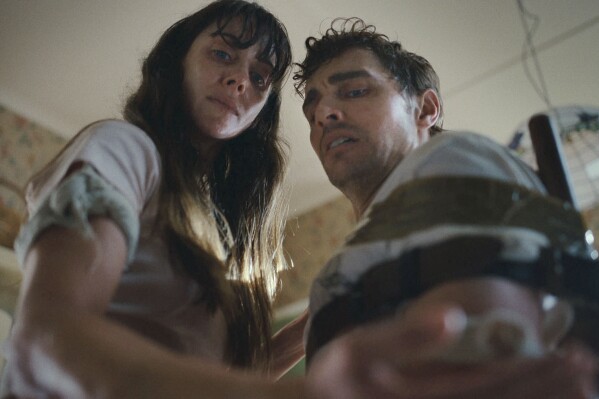 This image released by the Sundance Institute shows Alison Brie, left, and Dave Franco in a scene from "Together" by Michael Shanks, an official selection of the 2025 Sundance Film Festival. (Sundance Institute via AP)