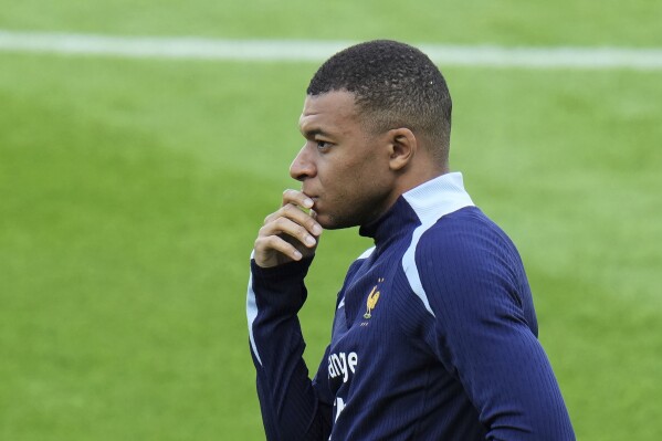 France's Kylian Mbappe gestures during a training session in Paderborn, Germany, Thursday, June 13, 2024. Mbappe was absent when the squad took part in an open practice session at its European Championship base on Thursday. France will play against Austria during their Group D soccer match at the Euro 2024 soccer tournament on June 17. (AP Photo/Hassan Ammar)