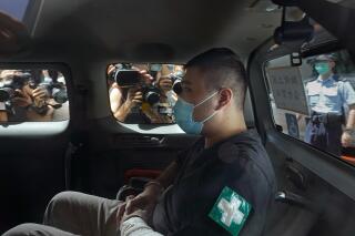 FILE - In this July 6, 2020, file photo, Tong Ying-kit arrives at a court in a police van in Hong Kong. A lawyer for Tong, who convicted under Hong Kong's national security law, asked Thursday, July 29, 2021, for no more than 10 years in prison instead of the possible life sentence faced by the former restaurant waiter in a closely watched case as China tries to crush a pro-democracy movement. (AP Photo/Vincent Yu, File)