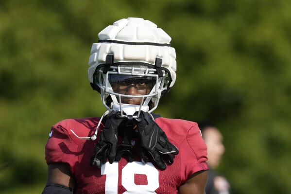 Arizona Cardinals wide receiver Marvin Harrison Jr. looks on during a joint NFL football practice with the Indianapolis Colts, Wednesday, Aug. 14, 2024, in Westfield, Ind. (AP Photo/Darron Cummings)