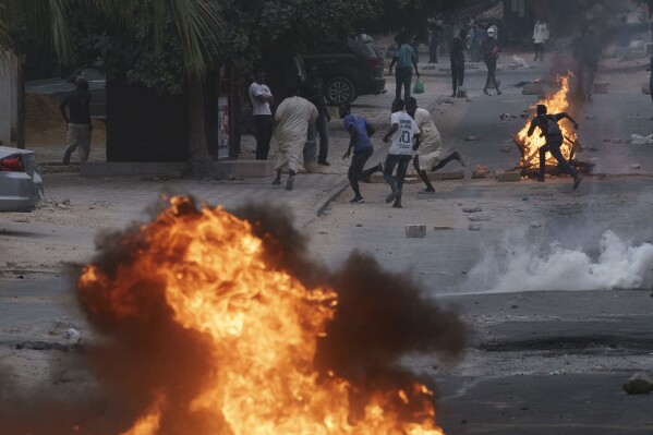 Demonstrators run after police officers fired tear gas during a protest in support of the main opposition leader Ousmane Sonko in Dakar, Senegal, Monday, May 29, 2023. (AP Photo/Leo Correa, File)
