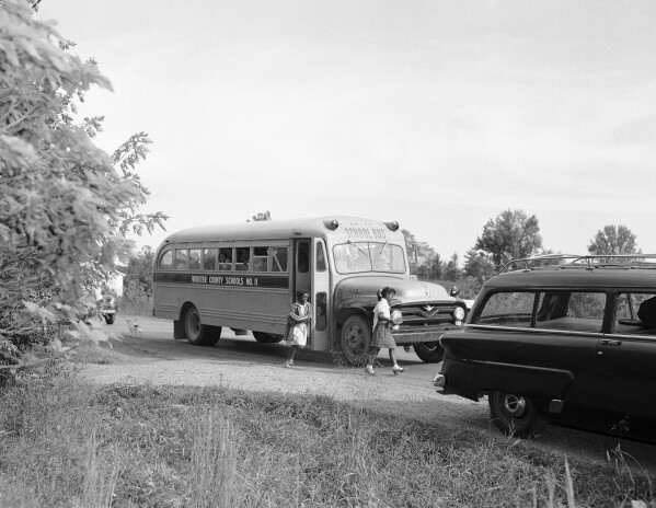 FILE - Buses transport Black students home from Rosenwald School, outside of Clay, Kentucky on Sept. 19, 1956. Seventy years after the Supreme Court's Brown v. Board, America is both more diverse — and more segregated. (AP Photo/HB Littell, File)