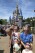 A family visiting from Sarasota watches the solar eclipse at the Magic Kingdom at Walt Disney World, in Lake Buena Vista, Fla., Monday, April 8, 2024. (Joe Burbank/Orlando Sentinel via AP)