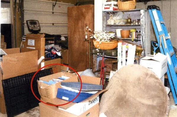 This image, contained in the report from special counsel Robert Hur, shows the box where classified Afghanistan documents were found in the garage of President Joe Biden in Wilmington, Del., during a search by the FBI on Dec. 21, 2022. (Justice Department via AP)