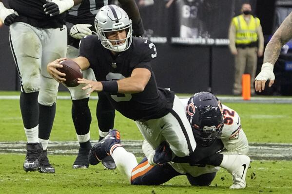 Las Vegas Raiders quarterback Nathan Peterman (3) is tackled by Chicago Bears outside linebacker Khalil Mack (52) during the second half of an NFL football game, Sunday, Oct. 10, 2021, in Las Vegas. (AP Photo/Rick Scuteri)