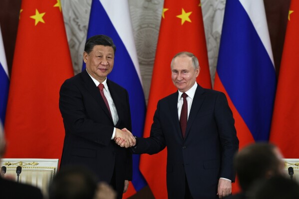 FILE - Russian President Vladimir Putin, right, and Chinese President Xi Jinping shake hands after speaking to the media during a signing ceremony following their talks at The Grand Kremlin Palace, in Moscow, Russia, March 21, 2023. Putin says his regime is prepared to negotiate over the conflict in Ukraine in an interview with Chinese media on the eve of visit to partner Beijing that has backed Moscow in its full-scale invasion of its neighbor. (Mikhail Tereshchenko, Sputnik, Kremlin Pool Photo via AP, File)
