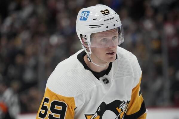 FILE - Pittsburgh Penguins left wing Jake Guentzel (59) in the second period of an NHL hockey game Wednesday, March 22, 2023, in Denver. Guentzel underwent right ankle surgery on Wednesday, Aug. 2, 2023, and will miss at least three months. (AP Photo/David Zalubowski, File)
