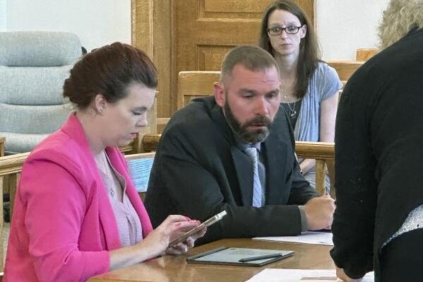Shawn Fix, center, confers with defense attorney Nichole Dougherty, left, during a court hearing at Antrim County Circuit Court in Bellaire, Mich. Wednesday, June 7, 2023. Fix pleaded guilty to providing material support for a terrorist act in connection with a 2020 plot to kidnap Gov. Gretchen Whitmer. (AP Photo/John Flesher)