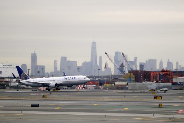 A United Airlines jet prepares touches down at Newark Liberty International Airport a day after a temporary grounding of aircraft was placed after reports of drones in the flight path, Wednesday, Jan. 23, 2019, in Newark, N.J. (AP Photo/Julio Cortez, File)