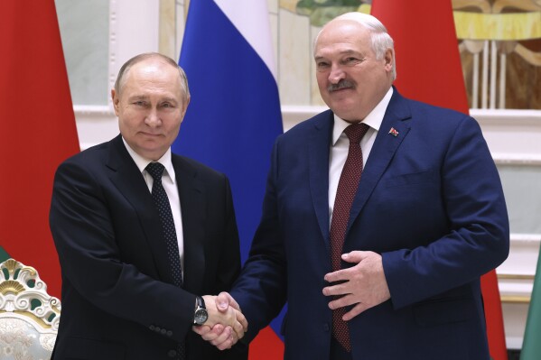 Russian President Vladimir Putin, left, and Belarusian President Alexander Lukashenko shake hands during a joint statement following Russian-Belarusian negotiations at the Palace of Independence in Minsk, Belarus, Friday, May 24, 2024. (Mikhail Metzel, Sputnik, Kremlin Pool Photo via AP)