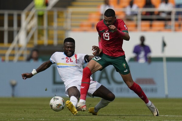 DR Congo's Chancel Mbemba, left, and Morocco's Youssef En-Nesyri challenge for the ball during the African Cup of Nations Group F soccer match between Morocco and DR Congo, at the Laurent Pokou stadium in San Pedro, Ivory Coast, Sunday, Jan. 21, 2024. (AP Photo/Themba Hadebe)