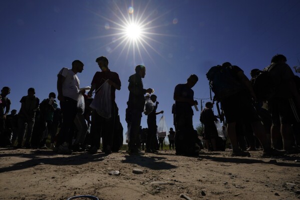 Migrants wait to be processed by U.S. Customs and Border Patrol after crossing the Rio Grande and entering the United States from Mexico, Thursday, Oct. 19, 2023, in Eagle Pass, Texas.  (AP Photo/Eric Gay)