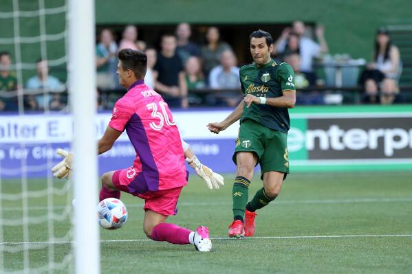 Portland Timbers midfielder Diego Valeri scores his 100th MLS goal, against Los Angeles FC goalie Tomás Romero during the first half of an MLS soccer match Wednesday, July 21, 2021, in Portland, Ore. (Sean Meagher/The Oregonian via AP)
