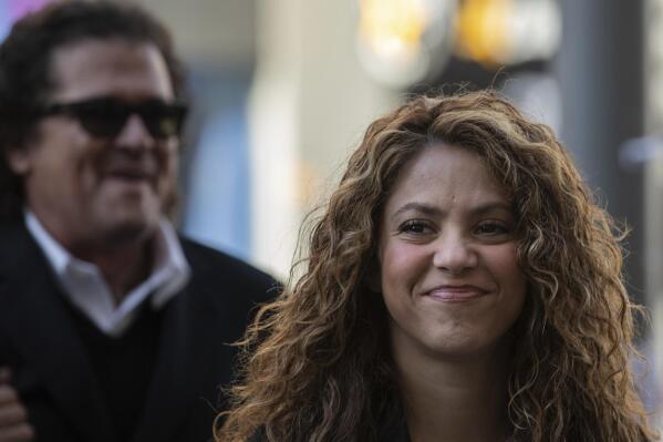 Colombian singers Shakira, right, and Carlos Vives, background, arrive at court in Madrid, Spain, Wednesday, March 27, 2019. Shakira and Vives have previously rejected allegations made by a Cuban-born singer and producer that they had plagiarized his work in their award-winning music hit "La Bicicleta". (AP Photo)