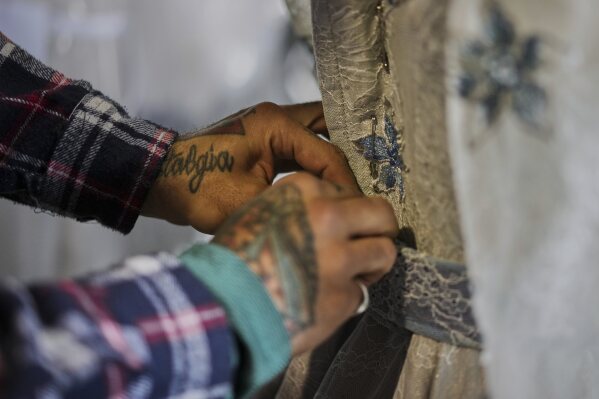 A tailor works on a stage costume for Giacomo Puccini's "Tosca" opera in the "Teatro dell' Opera" opera house costumes warehouse, in Rome, Thursday, April 10, 2025. (AP Photo/Andrew Medichini)