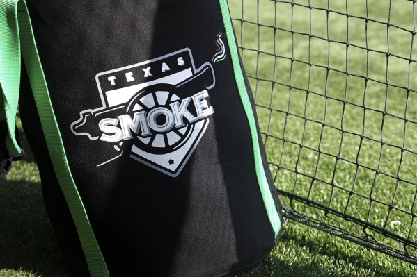 The Texas Smoke softball logo is displayed on a gear bag during practice at Concordia University in Austin, Texas, Monday, June 13, 2023. Former Major League Baseball star Brandon Phillips and current women's pro wrestler Jade Cargill took on professional sports franchise ownership together less than a year ago. The pair led the Texas Smoke to the championship in their first season with Women’s Professional Fastpitch softball. Majority ownership in major U.S. based leagues by anyone other than white men is rare. (Aaron Martinez/Austin American-Statesman via AP)