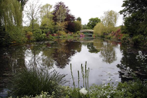 The Japanese-inspired water garden of Claude Monet's house, French impressionist painter who lived from 1883 to 1926, waits ahead of the re-opening, in Giverny, west of Paris, Monday May 17, 2021. Lucky visitors who'll be allowed back into Claude Monet's house and gardens for the first time in over six months from Wednesday will be treated to a riot of color, with tulips, peonies, forget-me-nots and an array of other flowers all competing for attention. (AP Photo/Francois Mori)