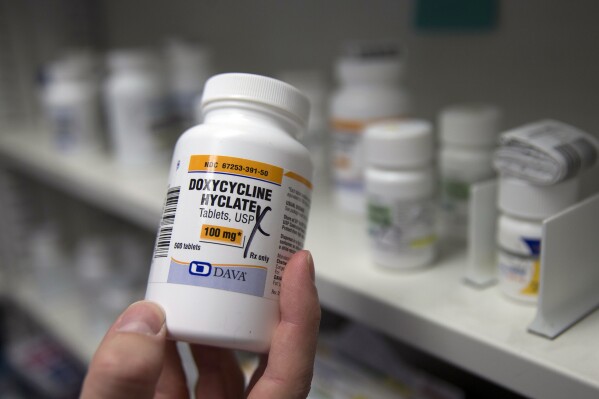 FILE - A pharmacist holds a bottle of the antibiotic doxycycline hyclate in Sacramento, Calif., July 8, 2016. The Centers for Disease Control and Prevention announced Monday, Oct. 2, 2023, that it plans to endorse the antibiotic as a post-sex morning after pill that gay and bisexual men can use to avoid some increasingly common sexually transmitted diseases. (AP Photo/Rich Pedroncelli, File)