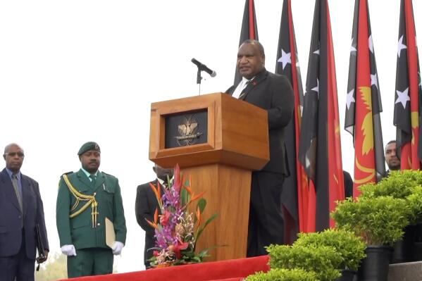 In an image taken from video, Papua New Guinea Prime Minister James Marape speaks during a ceremony marking the passing of Britain's Queen Elizabeth, Tuesday, Sept. 13, 2022, in Port Moresby, Papua New Guinea. Papua New Guinea leaders held a ceremony on Tuesday to farewell Queen Elizabeth II and to proclaim King Charles III as the country’s new head of state. (Australian Broadcasting Corporation via AP)