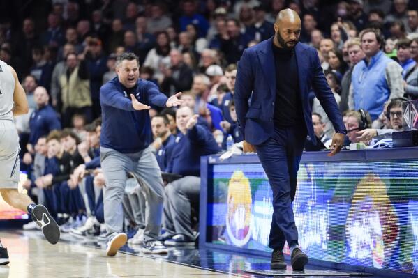 Villanova head coach Kyle Neptune, right, heads back to his bench as Xavier head coach Sean Miller reacts, left, during the second half of an NCAA college basketball game, Tuesday, Feb. 21, 2023, in Cincinnati. Neptune was assessed a technical foul for leaving his bench area. (AP Photo/Joshua A. Bickel)