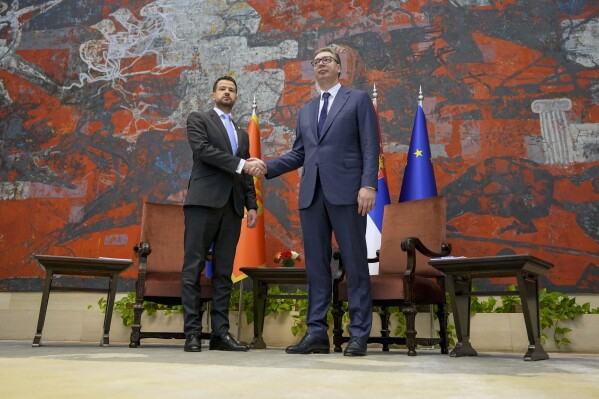 Montenegro's President Jakov Milatovic, left, shakes hands with his Serbian counterpart Aleksandar Vucic at the Serbia Palace in Belgrade, Serbia, Monday, July 10, 2023. Milatovic is on a two-day official visit to Serbia. (AP Photo/Darko Vojinovic)