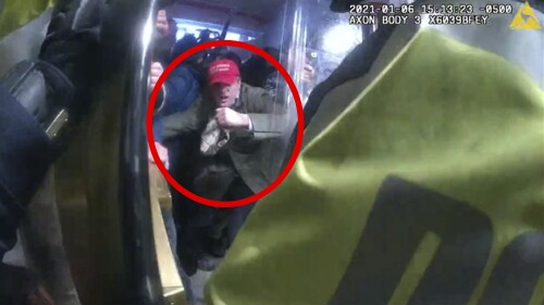 In this image from U.S. Capitol Police security video, released and annotated by the Justice Department in the Statement of Facts supporting an arrest warrant, Fredrico Guillermo Klein, circled in red, is seen in the tunnel of the Lower West Terrace of the U.S. Capitol on Jan. 6, 2021, in Washington. Klein who worked as a politically appointed State Department official in former President Donald Trump’s administration has been convicted of charges that he attacked police officers at the U.S. Capitol during a riot by a mob of Trump supporters. (Justice Department via AP)