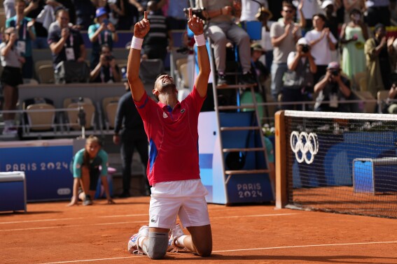 Serbia's Novak Djokovic reacts after defeating Spain's Carlos Alcaraz in the men's singles tennis final at the Roland Garros stadium during the 2024 Summer Olympics, Sunday, Aug. 4, 2024, in Paris, France. (AP Photo/Manu Fernandez)
