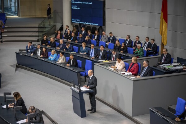 German Chancellor Olaf Scholz delivers a government statement on the situation in Israel during a meeting of the German federal parliament, Bundestag, at the Reichstag building in Berlin, Germany, Thursday, Oct. 12, 2023. (Michael Kappeler/dpa via AP)