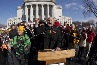 FILE - In this March 12, 2011 file photo, state Sen. Dave Hansen speaks at a rally outside the state Capitol in Madison, Wis. Hansen, a longtime Democratic Wisconsin state legislator announced Thursday, Jan. 9, 2020, that he will retire when his current term ends next January. (AP Photo/Morry Gash, File)