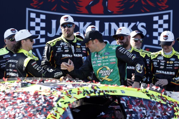 NASCAR Cup Series driver Austin Cindric celebrates with crew after winning a NASCAR Cup Series auto race at Talladega Superspeedway, Sunday, April 27, 2025, in Talladega, Ala. (AP Photo/Butch Dill)