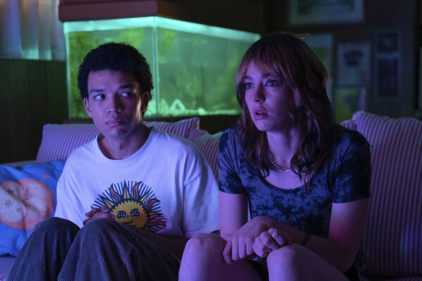 This image released by A24 shows Justice Smith, left, and Brigette Lundy-Paine in a scene from "I Saw the TV Glow." (A24 via Ǻ)