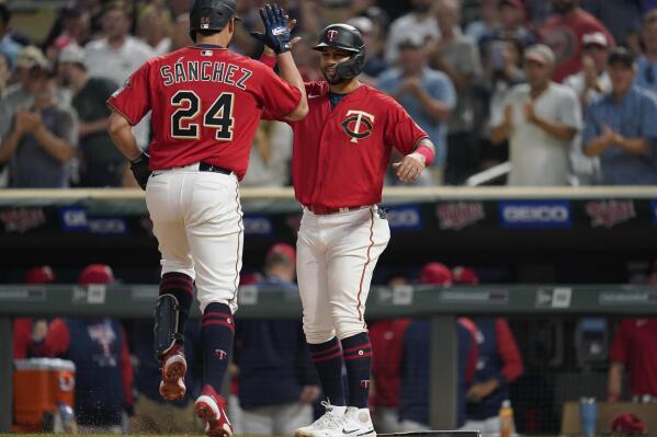 Minnesota Twins' Gary Sanchez, left, celebrates with Gilberto Celestino, right, after hitting a two-run home run against the San Francisco Giants during the third inning of a baseball game Friday, Aug. 26, 2022, in Minneapolis. (AP Photo/Abbie Parr)