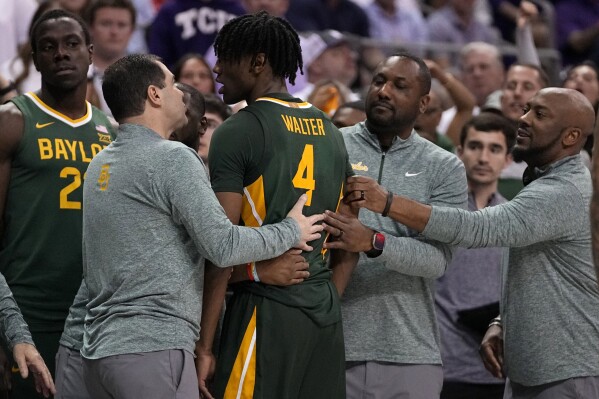 Baylor head coach Scott Drew, front left, talks to guard Ja'Kobe Walter (4) after tempers flared on the court in the second half of an NCAA college basketball game against TCU in Fort Worth, Texas, Monday, Feb. 26, 2024. (AP Photo/Tony Gutierrez)